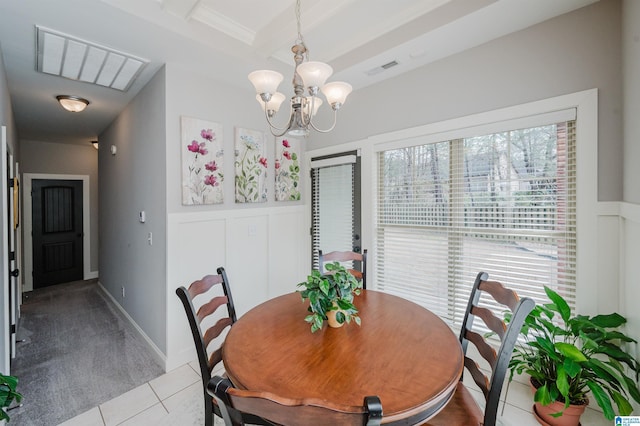 dining space featuring a wainscoted wall, tile patterned flooring, carpet floors, a decorative wall, and beam ceiling