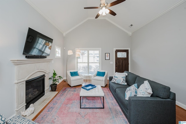 living room with visible vents, ornamental molding, a fireplace with flush hearth, vaulted ceiling, and wood finished floors