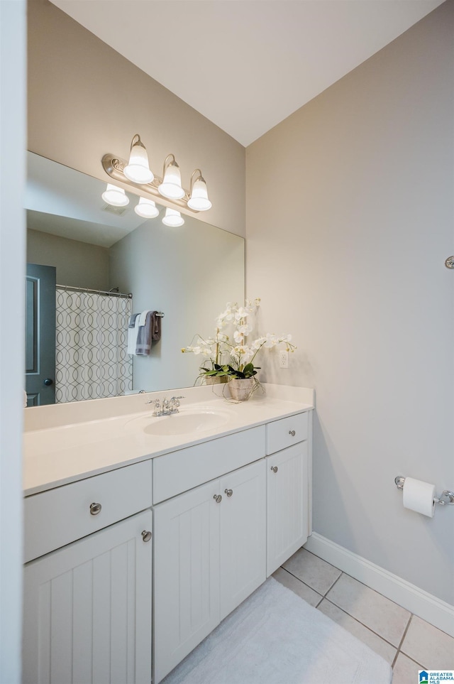 full bath with tile patterned flooring, vanity, and baseboards