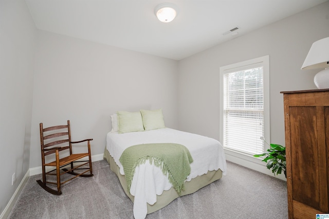 carpeted bedroom with baseboards and visible vents