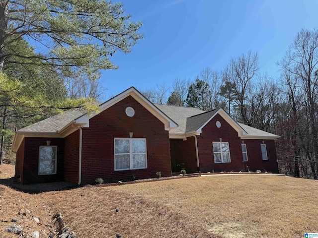 single story home with a front lawn and brick siding