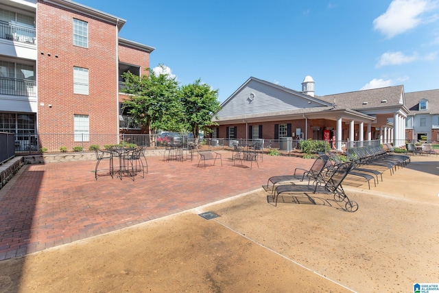 view of community featuring fence and a patio