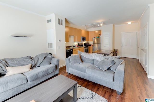 living area featuring dark wood-style floors, visible vents, and crown molding