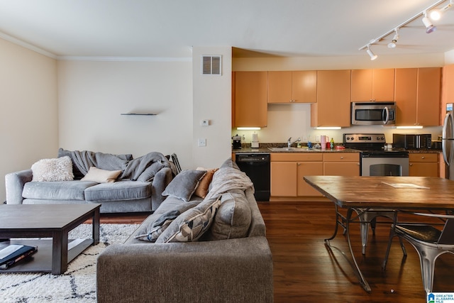 kitchen featuring dark wood-style flooring, stainless steel appliances, dark countertops, visible vents, and open floor plan