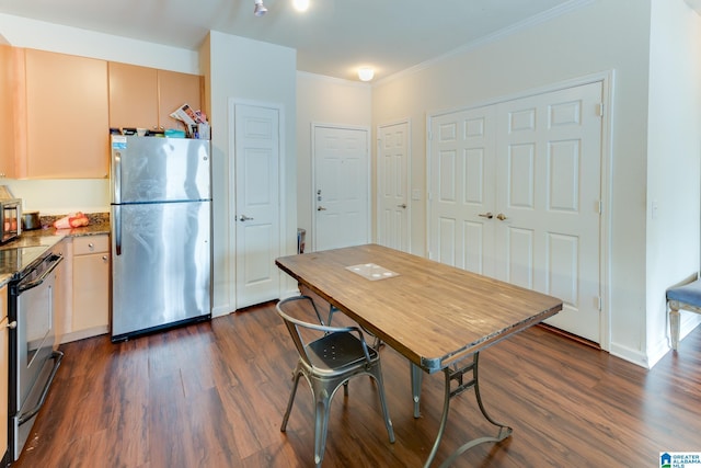 kitchen with stone counters, baseboards, appliances with stainless steel finishes, dark wood-style floors, and crown molding