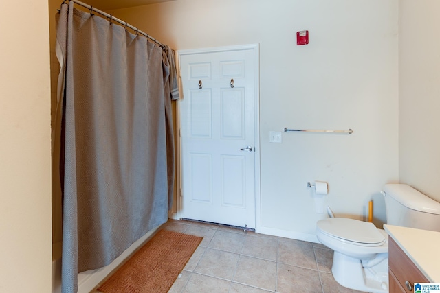 bathroom featuring a shower with curtain, vanity, toilet, and tile patterned floors