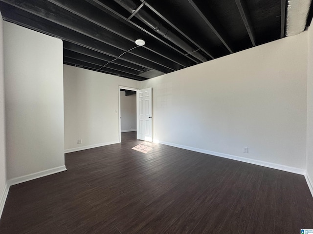 interior space featuring baseboards and dark wood-type flooring