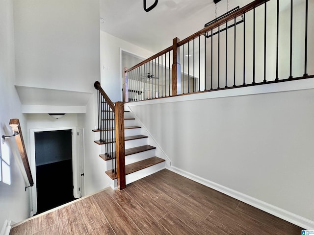 stairs featuring baseboards and wood finished floors