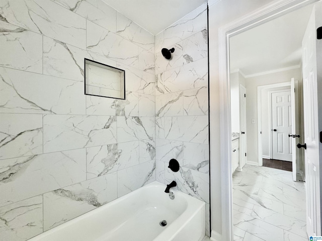 bathroom with marble finish floor, ornamental molding, bathtub / shower combination, and baseboards