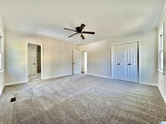 unfurnished bedroom featuring carpet, baseboards, and ornamental molding