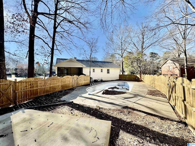 view of yard featuring a patio area, a fenced backyard, and an outbuilding