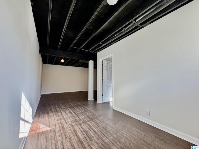 interior space with baseboards and wood finished floors