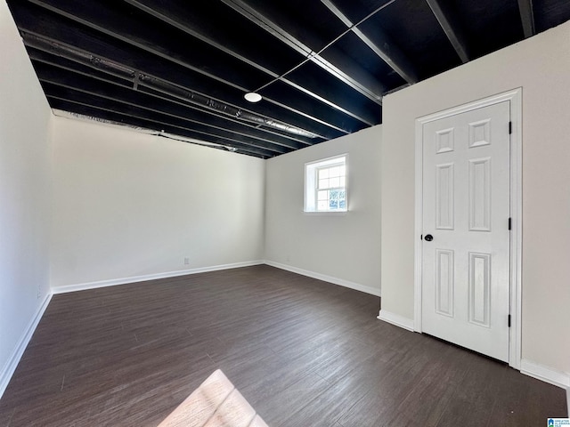 basement with dark wood-style floors and baseboards