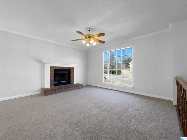 unfurnished living room with baseboards, a textured ceiling, a fireplace, and crown molding