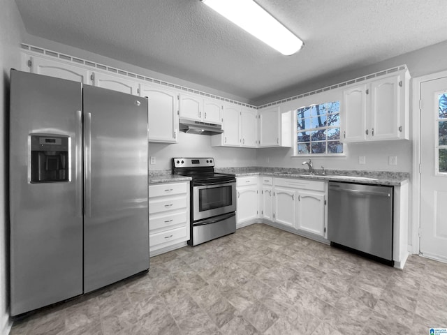 kitchen with stainless steel appliances, a wealth of natural light, white cabinetry, and under cabinet range hood