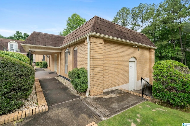 171 Old Montgomery Hwy Unit A, Homewood, AL 35216 - view of home's exterior with mansard roof and brick siding
