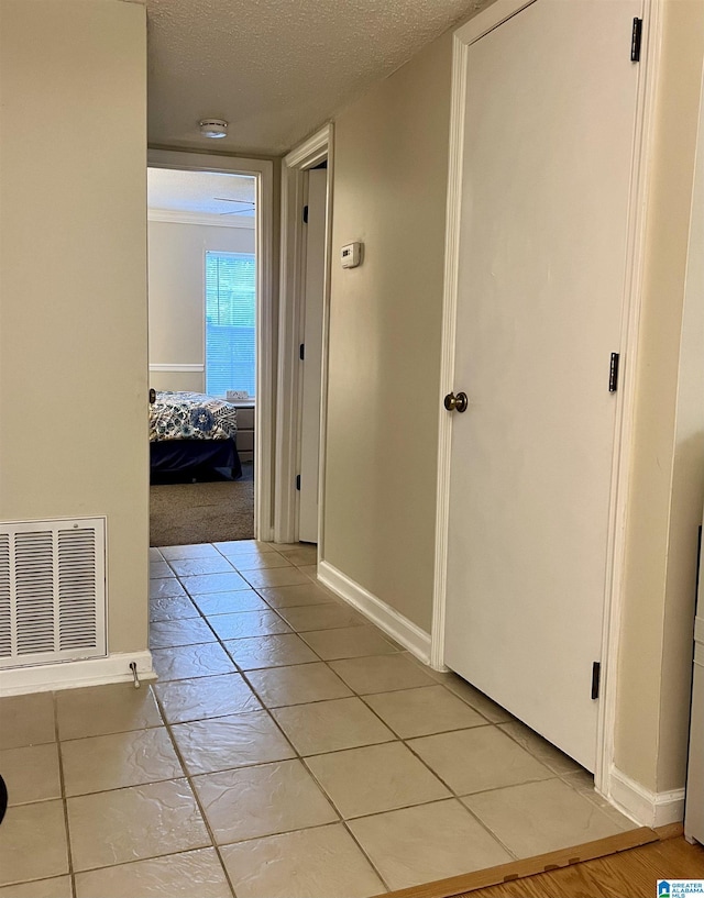 171 Old Montgomery Hwy Unit A, Homewood, AL 35216 - hall featuring a textured ceiling, baseboards, and light tile patterned floors