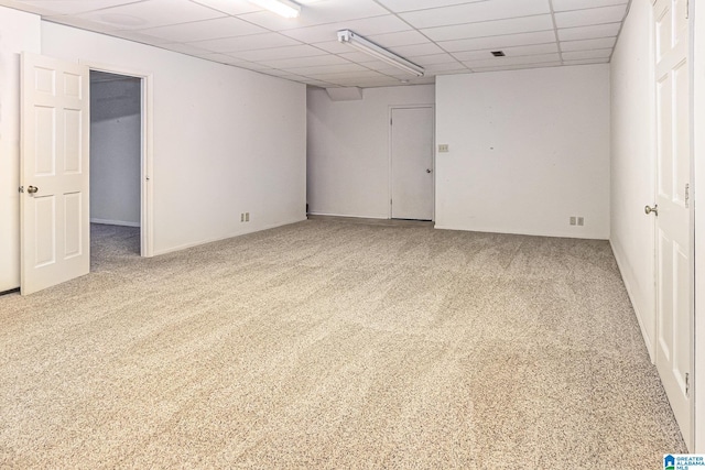 carpeted spare room with a paneled ceiling