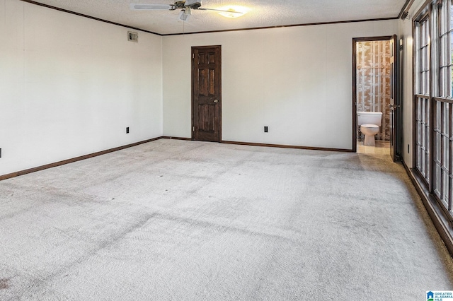 unfurnished bedroom with carpet flooring, visible vents, and crown molding