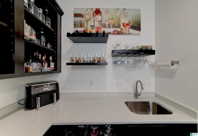 bar with wet bar and a sink