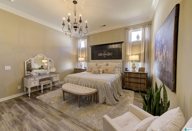 bedroom featuring ornamental molding, visible vents, baseboards, and wood finished floors