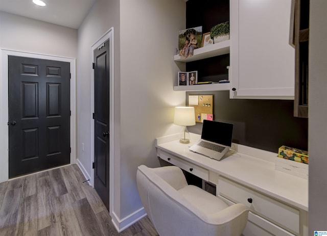 office space with built in desk, recessed lighting, wood finished floors, and baseboards