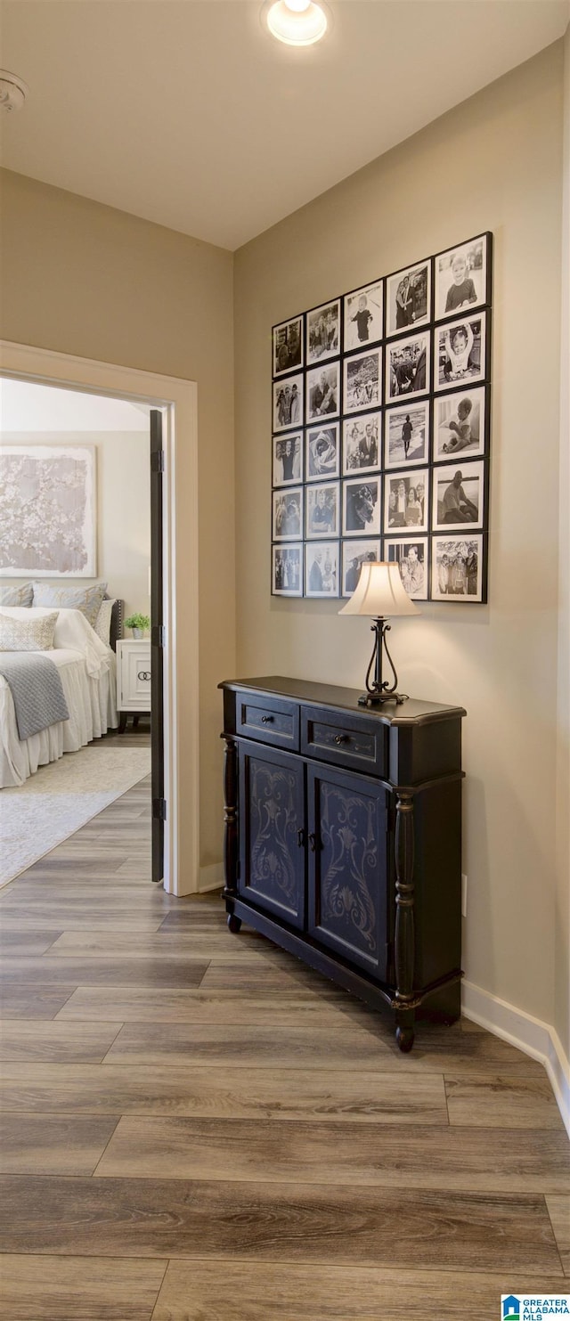 hallway with wood finished floors and baseboards