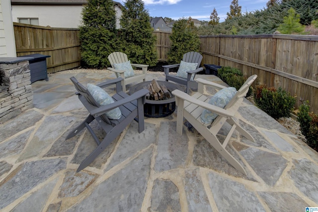 view of patio with an outdoor fire pit and a fenced backyard