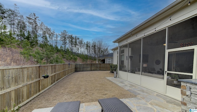 view of patio / terrace with a fenced backyard and a sunroom