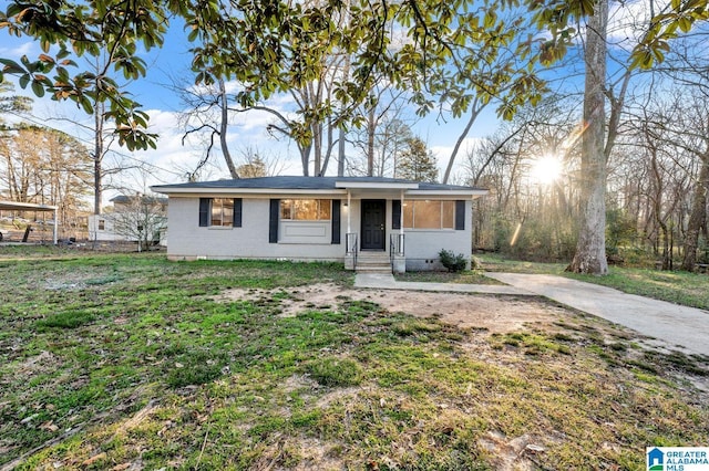 view of front of property with crawl space, brick siding, fence, and a front lawn