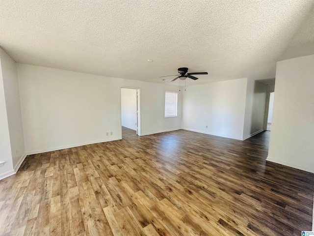 unfurnished living room featuring a ceiling fan, a textured ceiling, baseboards, and wood finished floors