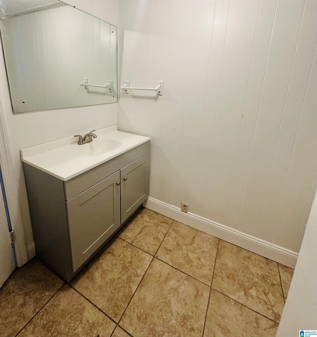 bathroom with baseboards, vanity, and tile patterned floors