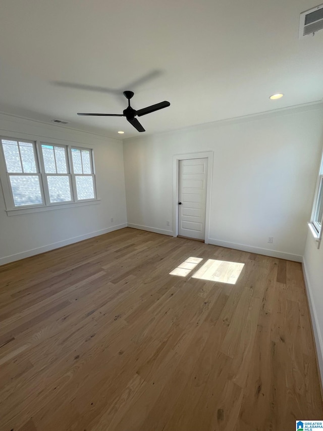 empty room with baseboards, visible vents, ceiling fan, wood finished floors, and recessed lighting