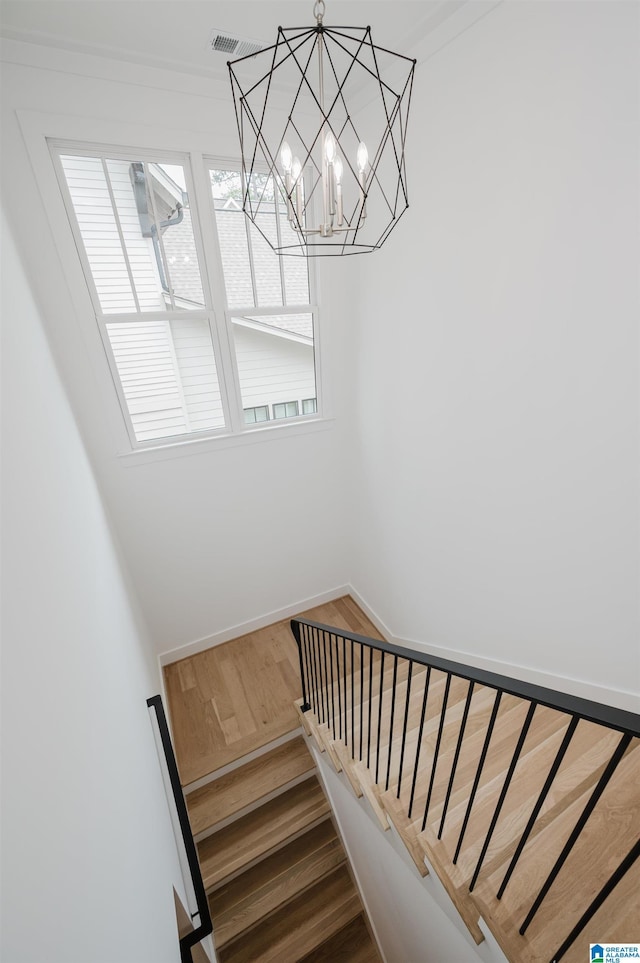 212 Olmsted St, Birmingham, AL 35242 - stairs with wood finished floors, baseboards, and a chandelier