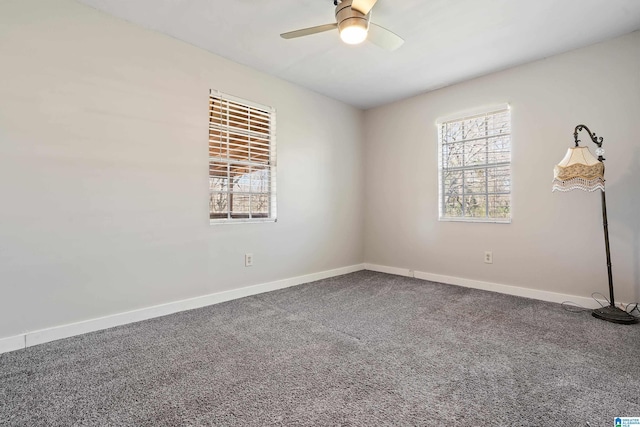 empty room featuring baseboards, carpet floors, and ceiling fan