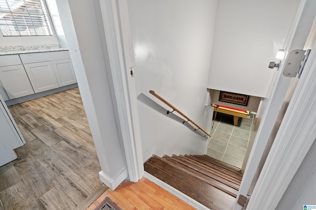 stairs featuring wood finished floors