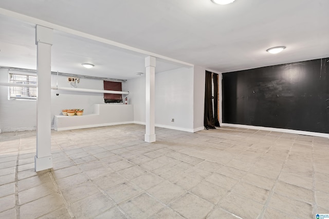 basement featuring baseboards and light floors