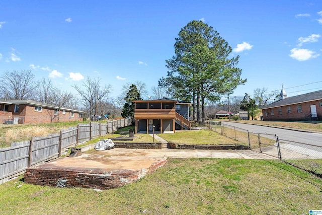 exterior space with a gate, stairway, a fenced backyard, and a patio area