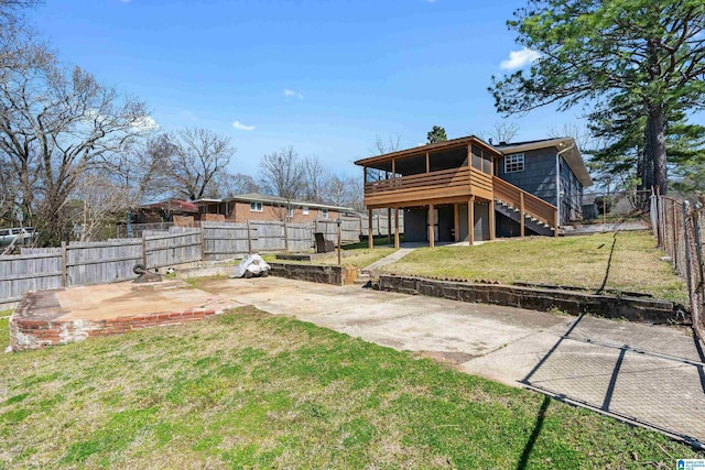 rear view of property with a lawn, a patio, a fenced backyard, a sunroom, and stairs