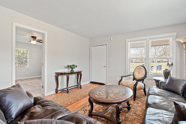 living area featuring light wood-style flooring and baseboards