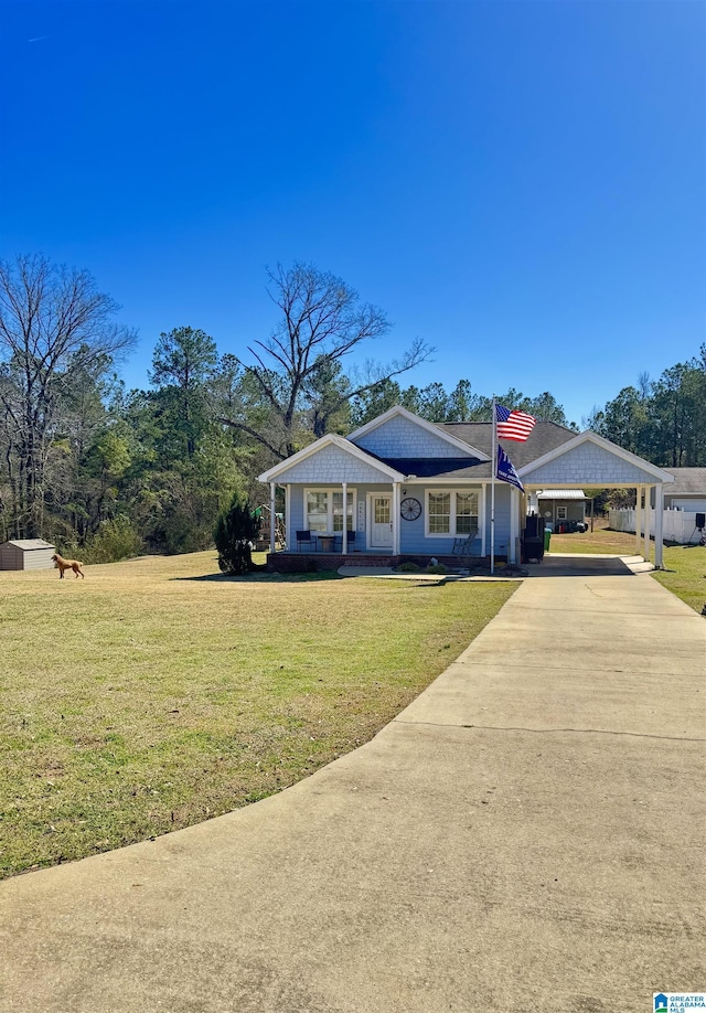 view of front of home featuring a carport, covered porch, driveway, and a front lawn