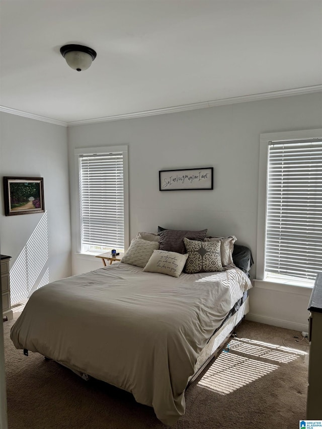 bedroom featuring carpet floors, baseboards, and crown molding