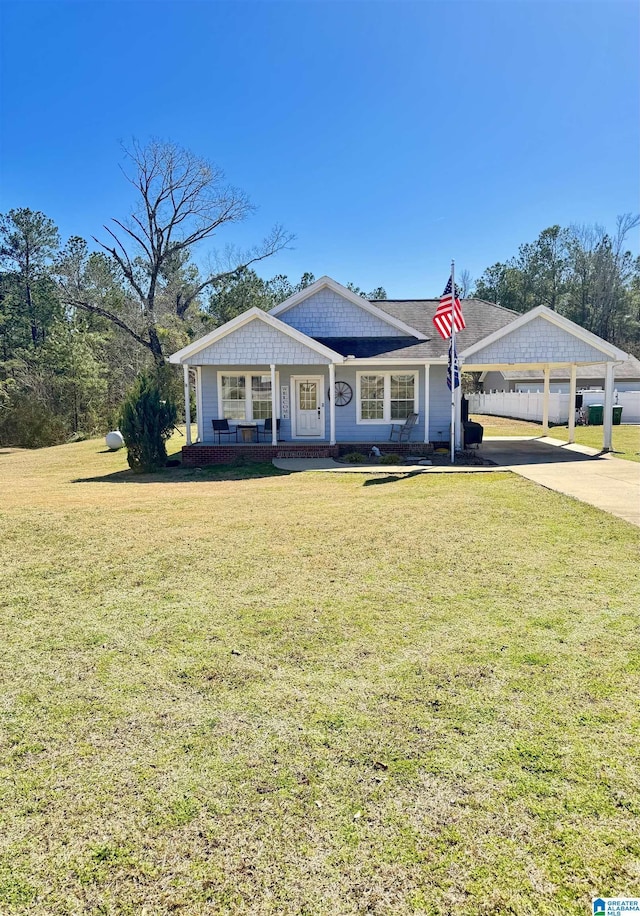 view of front of house with a porch, a carport, and a front lawn