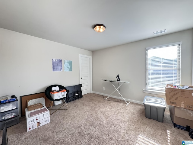 misc room with carpet floors, baseboards, and visible vents