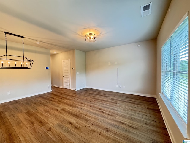 212 Buckhorn Cir, Weaver, AL 36277 - spare room with a chandelier, wood finished floors, and baseboards