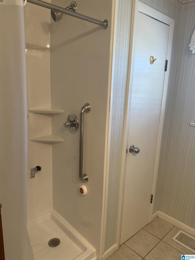 full bath with a shower stall, visible vents, and tile patterned floors