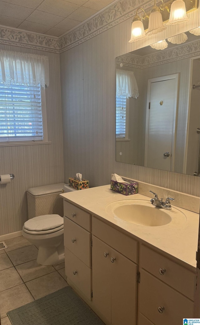 bathroom featuring toilet, tile patterned flooring, and vanity