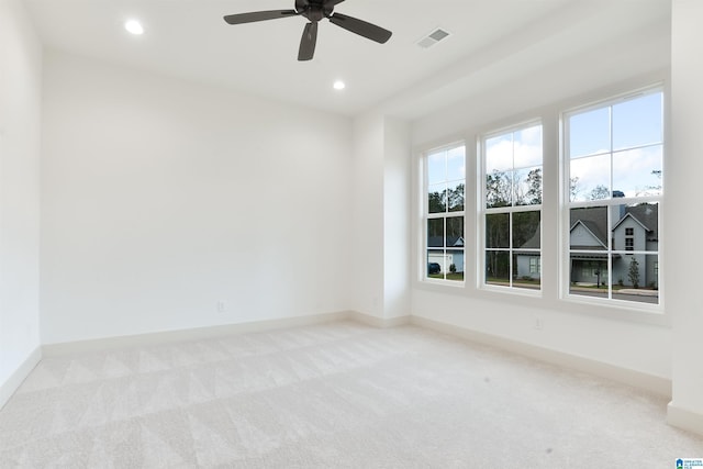 carpeted empty room featuring baseboards, visible vents, ceiling fan, and recessed lighting