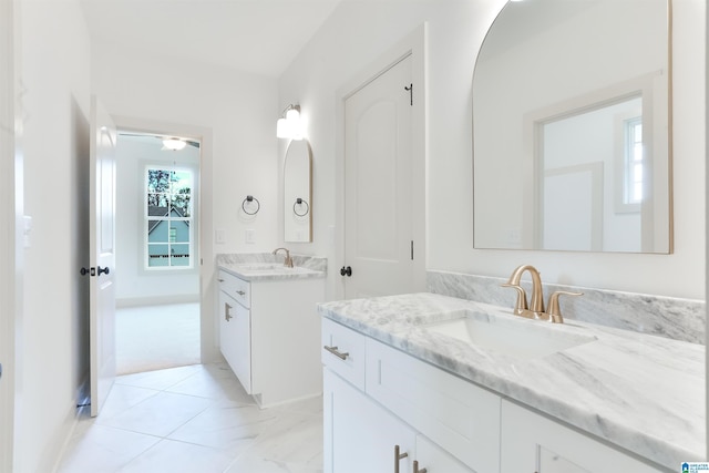 full bath with two vanities and a sink