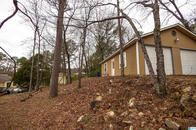 view of side of property with a garage and an outdoor structure